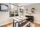 Modern dining area with bench seating and large window at 2438 Welton St, Denver, CO 80205