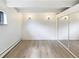 Bedroom featuring new flooring, a window, and a closet with mirrored doors at 2401 S Gaylord St # 206, Denver, CO 80210