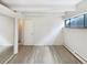 This bedroom has a closet with mirrored doors, new flooring, a window, and fresh white walls at 2401 S Gaylord St # 206, Denver, CO 80210