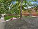 Community landscape featuring mature trees, seating, and bike racks at 2401 S Gaylord St # 206, Denver, CO 80210