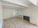 The open living room features updated floors, white walls and a brick fireplace at 2401 S Gaylord St # 206, Denver, CO 80210