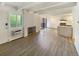 Bright living room featuring wood-look flooring, brick fireplace, and sliding glass door to a patio at 2401 S Gaylord St # 206, Denver, CO 80210