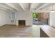 The living room features a fireplace, new flooring, and a sliding glass door to a balcony at 2401 S Gaylord St # 206, Denver, CO 80210