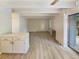 Open living space featuring wood-look flooring, white brick fireplace, and access to a balcony at 2401 S Gaylord St # 206, Denver, CO 80210