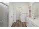 A bathroom features a walk-in shower, dual vanity, and access to closet at 1975 S Coolidge Way, Aurora, CO 80018