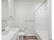 Clean bathroom with white fixtures, including a tub-shower combination, toilet, and single sink vanity at 1975 S Coolidge Way, Aurora, CO 80018