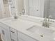 A dual vanity features white counters and cabinets, with chrome hardware at 1975 S Coolidge Way, Aurora, CO 80018