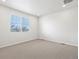 A bright bedroom with carpeted floors features a large window at 1975 S Coolidge Way, Aurora, CO 80018