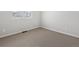 Neutral bedroom featuring neutral carpeting, a window, and white walls at 1975 S Coolidge Way, Aurora, CO 80018