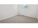 A bright bedroom features carpeted floors and a window at 1975 S Coolidge Way, Aurora, CO 80018