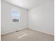 Neutral bedroom featuring neutral carpeting, a window, and white walls at 1975 S Coolidge Way, Aurora, CO 80018