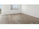 An empty bedroom with light wood vinyl flooring and a large window at 1975 S Coolidge Way, Aurora, CO 80018