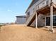 Exterior view showcasing stone and vinyl siding with outdoor staircase to backyard at 1975 S Coolidge Way, Aurora, CO 80018