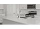 Modern kitchen with white cabinets, stainless steel appliances, and a large center island at 1975 S Coolidge Way, Aurora, CO 80018