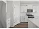 Modern kitchen with white cabinets, stainless steel appliances, and a large center island at 1975 S Coolidge Way, Aurora, CO 80018