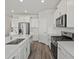 Modern kitchen with white cabinets, stainless steel appliances, and a large center island at 1975 S Coolidge Way, Aurora, CO 80018