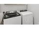 Modern laundry room with white Whirlpool washer and dryer units at 1975 S Coolidge Way, Aurora, CO 80018