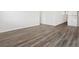 An empty living room features light wood-look vinyl flooring at 1975 S Coolidge Way, Aurora, CO 80018