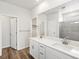 A dual vanity with white counters and cabinets, with a shower and closet at 1975 S Coolidge Way, Aurora, CO 80018