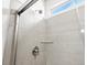 A walk-in shower with gray tiling features a glass door at 1975 S Coolidge Way, Aurora, CO 80018