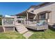 Backyard featuring a wooden deck with a covered section and shade at 3838 S Waco St, Aurora, CO 80013