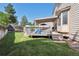 Large backyard featuring a deck, wooden fence, and a mature grassy lawn at 3838 S Waco St, Aurora, CO 80013