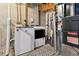 Unfinished basement utility area with modern washer and dryer hookups at 3838 S Waco St, Aurora, CO 80013