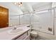 Compact bathroom features a shower-tub combination and vanity with ample storage at 3838 S Waco St, Aurora, CO 80013