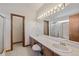 Bathroom with double sinks and a full shower and tub, great lighting and a large mirror at 3838 S Waco St, Aurora, CO 80013