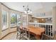 Elegant dining room featuring a large table, bay window, and stylish light fixture at 3838 S Waco St, Aurora, CO 80013