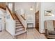 Bright foyer with wood floors, staircase, and decorative accents creating a warm entrance at 3838 S Waco St, Aurora, CO 80013