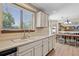 Bright kitchen with ample counter space, a double sink, and a view of the dining area at 3838 S Waco St, Aurora, CO 80013