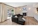 Relaxing living area featuring a fireplace, access to the outdoors, and wood flooring at 3838 S Waco St, Aurora, CO 80013