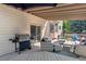 Outdoor patio with grill, bay window, and comfortable seating with a sunshade at 3838 S Waco St, Aurora, CO 80013