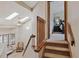 View of staircase featuring light from large windows, and a ceiling fan at 3838 S Waco St, Aurora, CO 80013