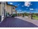 Expansive back deck with dark wood and iron railings overlooking a lush lawn and manicured landscaping at 7343 Upton Ct, Castle Rock, CO 80104