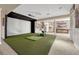 Basement home theater area with large screen, kitchenette, and golf simulator at 7343 Upton Ct, Castle Rock, CO 80104