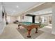 Finished basement with a pool table, theater area, kitchenette and neutral carpet at 7343 Upton Ct, Castle Rock, CO 80104
