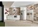 Finished basement area featuring a kitchenette with stone backsplash, stainless steel appliances, and a built-in bar area at 7343 Upton Ct, Castle Rock, CO 80104