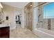 Bathroom featuring a glass shower, bathtub, and marble floors near a modern-style vanity with a granite countertop at 7343 Upton Ct, Castle Rock, CO 80104