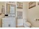 Half bath featuring an ornate mirror over a vanity with stone countertop at 7343 Upton Ct, Castle Rock, CO 80104