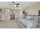 Spacious bedroom featuring a ceiling fan, neutral tones, and a walk-in closet with great natural light at 7343 Upton Ct, Castle Rock, CO 80104