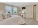 Comfortable bedroom featuring a vanity, soft carpeting, and bright, sheer curtains at 7343 Upton Ct, Castle Rock, CO 80104