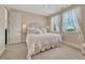 Charming bedroom with decorative headboard and two windows with flowing white curtains at 7343 Upton Ct, Castle Rock, CO 80104