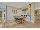 Spacious dining room with travertine floors, natural lighting, and elegant chandelier at 7343 Upton Ct, Castle Rock, CO 80104