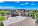 Stunning two-story home with a stone facade, lush landscaping, and a large driveway with basketball court at 7343 Upton Ct, Castle Rock, CO 80104