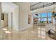Bright, open foyer with soaring ceilings, marble floors, and wrought iron railing on the second-story overlook at 7343 Upton Ct, Castle Rock, CO 80104