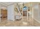 Grand foyer featuring travertine floors, high ceilings, large windows and decorative staircase at 7343 Upton Ct, Castle Rock, CO 80104