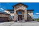Grand home entrance with stone archway, double doors, and manicured landscaping at 7343 Upton Ct, Castle Rock, CO 80104