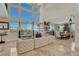 Light-filled living room with two-story windows, plush seating, and access to the outdoor deck at 7343 Upton Ct, Castle Rock, CO 80104